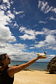Young man holding a bird, Madagascar