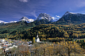Scuol with Piz Lischana and trees in autumn colours, Engadin, Grisons, Switzerland