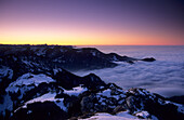 Kampenwand at dusk with view to fogbanky in tghe valley of Prien and the land in front of the Bavarian alps, Chiemgau, Upper Bavaria, Bavaria, Germany