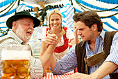 Two men arm wrestling in a beer tent