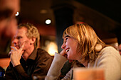 Skiers celebrating in an apres ski bar after skiing, Saltlik, Banff, Alberta, Canada