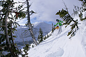 Two skiers on slope, Castle Mountain ski resort, Alberta, Canada
