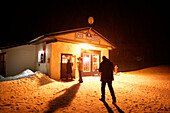 Three people entering a Pub, T-Bar, Castle Mountain Ski Resort, Southern Alberta, Canada