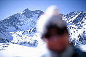 Skiing woman out of focus, view to snow covered mountains, Lazaun mountain station, Schnals Valley, South Tyrol, Italy, MR