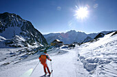 Skiers on run to alpine hut Bella Vista, Schnalstal, South Tyrol, Italy