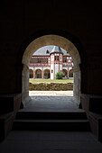 Dark alley leading to the light-flooded courtyard of Eberbach Abbey, Rheingau, Hesse, Germany