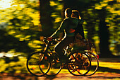 Cyclists in autumnal English Garden, Munich, Bavaria, Germany