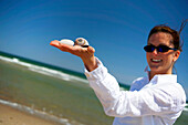 A woman holding seashells, Nauset Beach, Orleans, Cape Cod, Massachusetts, USA