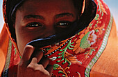 Muslim girl behind colorful veil, Bwejuu, Unguja, Zanzibar, Tanzania, Africa