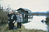 Two boys at a lake with fishing rods