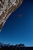 Alpinist hanging on rope, Tofana, Dolomites