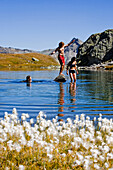 Three young people bathing in lake Laghi della Valletta, Gotthard, Canton of Ticino, Switzerland
