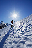 Back-country skier ascending Leutkircher Hütte, Lechtal Alps, Vorarlberg, Austria
