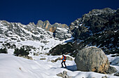 crosscountry skiier beneath Wildalmkirchl, Berchtesgaden range, Salzburg, Austria
