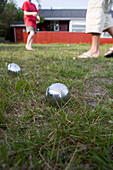 Vater und Sohn spielen Boccia vor Ferienhaus, Henne Strand, Jütland, Dänemark, Europa