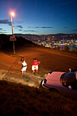 Polynesian girls from Samoa dancing to music from their car. Friday night on Mt. Victoria. Overlooking citycentre of Wellington, North Island, New Zealand