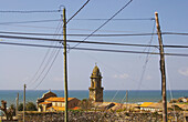 Former monastery, Monasterio de Oia, with pylons in the foreground, Oia, Rías Bajas, Galicia, Spain