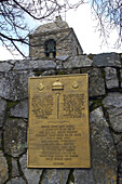 Church in the village of Pedrafita do Cebreiro showing plaque with scallop shell, Ancares Leonenses, Cordillera Cantabrica, Pedrafita do Cebreiro, Galicia, Spain