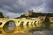 Roman bridge over the river Orb and view of town and cathedral, Beziers, Department Herault, France