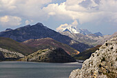 Landscape with reservoir, Embalse de los Barrios de Luna, and snow topped mountains, Codillera Cantabrica, Castilla Leon, Spain