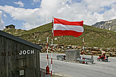 Austrian flag, motorbike tour in June over alpine passes, summit pass at Timmelsjoch between Austria and Italy
