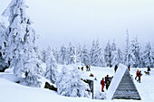 Tourists on snow covered Brocken summit, Schierke, Harz Mountains, Saxony-Anhalt, Germany