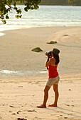 Thai girl, woman, taking pictures on the beach, Surin Islands Marine National Park, headquarters, Ko Surin, Phang Nga, Thailand