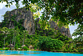 Bungalows in tropical garden of Hotel Rayavadee with limestone cliffs, Hat Phra Nang, Krabi, Thailand