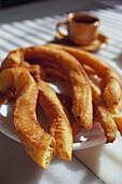 Churros con chocolate, a kind of funnel cake served with a cup of hot chocolate, Close-up
