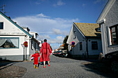 Two locals, woman and child, returing home in bathrobes after a swim, Torekov, Skane, Sweden