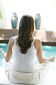 Woman meditating near a pool, Relaxation, Health, Wellness