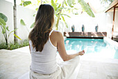 Woman meditating by a pool, Quietness, Relaxation, Wellness