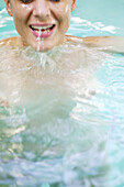 Frau mittleren Alters badet in einem Pool, Steiermark, Österreich