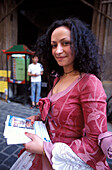 Woman wearing traditonal costume handing out flyers, Karlova Street, Old Town, Prague, Czech Republic