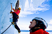 Ice climber in frozen waterfall, Kaldakinn, Iceland