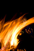 Person warming up at campfire