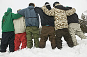 Group of friends with the same snowboard look . Lappland. Ivalo. Finland