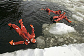 Diving in iced Baltic Sea, floating with special costumes. Sampo Icebreaker. Kemi. Gulf of Bothnia. Baltic Sea. Finland.