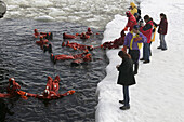 Diving in iced Baltic Sea, floating with special costumes. Sampo Icebreaker. Kemi. Gulf of Bothnia. Baltic Sea. Finland.