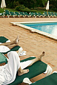 Relaxing by the pool at Hotel Termes Montbrió at night, Montbrió del Camp. Tarragona province, Catalonia, Spain