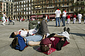 Taking a break from the party during San Fermin Festival. Pamplona. Navarre, Spain