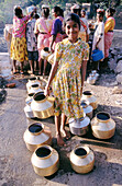 Girl filling water , India