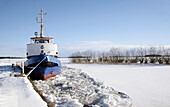 A tug boat at wintertime in the harbour in Västerås, Sweden