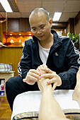 Foot massage at Kwong Tai Foot Reflexology Clinic. Hong Kong. China.