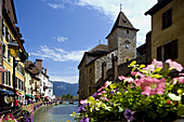 The Palais (palace) de l Ile, the Thiou river and the flowers of the riverside. Annecy. France.