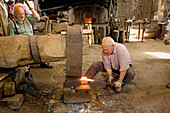 Working in the Fucina Museo (Forge Museum). Bienno. Lombardia-Valcamonica. Italy.