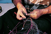 Fisherman mending net. Marsaxlokk. Malta
