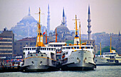 Ferries pier and Suleimaniye mosque in background. Istanbul. Turkey