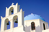 Colored belfry and church dome. Santorini island. Cyclades. Greece