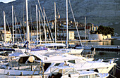 Boats at marina and the fortified town in background. Korcula Island. Croatia